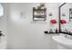 Neutral-toned half bath featuring a pedestal sink, mirror, and wall shelving with decor at 2906 Clarabelle Ct, Kissimmee, FL 34743