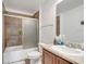 Neutral-toned bathroom featuring a shower with sliding glass doors and a wood vanity at 2906 Clarabelle Ct, Kissimmee, FL 34743