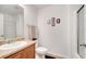 Well-lit bathroom featuring a single sink vanity, framed art and a shower with glass door at 2906 Clarabelle Ct, Kissimmee, FL 34743