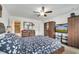 Well-lit bedroom with a ceiling fan, dresser, and TV setup for a comfortable living space at 2906 Clarabelle Ct, Kissimmee, FL 34743