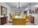 Bright dining room with yellow chairs, a chandelier and view of the backyard at 2906 Clarabelle Ct, Kissimmee, FL 34743