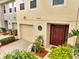 Charming front door of this townhome, with garage, landscaping and an inviting entrance at 2906 Clarabelle Ct, Kissimmee, FL 34743