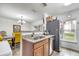 Modern kitchen featuring stainless steel appliances, granite countertops, and a pass-through window at 2906 Clarabelle Ct, Kissimmee, FL 34743