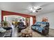 Cozy living room with tile flooring, ceiling fan and an archway to the dining room at 2906 Clarabelle Ct, Kissimmee, FL 34743