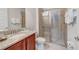 Bathroom with a granite vanity, tiled shower, and modern fixtures at 310 Pendant Ct, Kissimmee, FL 34747