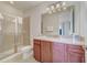 The bathroom features a shower, granite countertops, and modern lighting at 310 Pendant Ct, Kissimmee, FL 34747