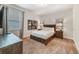 Cozy bedroom with a comfortable bed, wood furniture, and soft carpet flooring at 310 Pendant Ct, Kissimmee, FL 34747