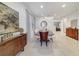 Elegant dining room with a large table, modern decor, and tile flooring at 310 Pendant Ct, Kissimmee, FL 34747