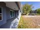 Covered back porch with sliding glass doors provides access to the backyard and a trampoline at 3209 Hanley St, Deltona, FL 32738