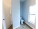 Bathroom featuring a toilet and window with modern wood look flooring at 3209 Hanley St, Deltona, FL 32738