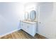 Bathroom featuring double sinks with modern mirrors and white cabinets at 3209 Hanley St, Deltona, FL 32738