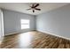 A bright bedroom offers a ceiling fan and modern wood flooring at 3209 Hanley St, Deltona, FL 32738