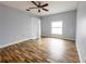 Bedroom featuring light walls, wood-look flooring, sliding glass doors and large bright windows at 3209 Hanley St, Deltona, FL 32738