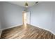 Comfortable bedroom with wood floors, a modern light fixture and an ensuite bathroom at 3209 Hanley St, Deltona, FL 32738