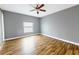 Neutral bedroom featuring a ceiling fan and a large window at 3209 Hanley St, Deltona, FL 32738