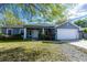 Charming single-story home with a well-manicured lawn and attached two-car garage at 3209 Hanley St, Deltona, FL 32738