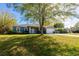 Attractive single-story home with a lush front yard and attached two-car garage at 3209 Hanley St, Deltona, FL 32738