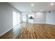 Open-concept living room features wood flooring, recessed lighting, and a seamless transition to the modern kitchen at 3209 Hanley St, Deltona, FL 32738