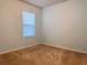 Empty carpeted bedroom featuring a window with blinds and neutral wall color with white trim at 398 Citrus Isle Loop, Davenport, FL 33837