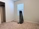 Bedroom includes carpet and a window and a Total Gym, allowing for natural light and a dedicated workout space at 398 Citrus Isle Loop, Davenport, FL 33837