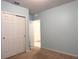 Empty carpeted bedroom featuring a closet with sliding doors and neutral wall color with white trim at 398 Citrus Isle Loop, Davenport, FL 33837