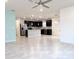 Open floor plan showcasing the kitchen with stainless steel appliances and connecting living space at 398 Citrus Isle Loop, Davenport, FL 33837