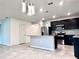 Bright, open kitchen with granite countertops, dark cabinets, stainless appliances, and modern pendant lighting at 398 Citrus Isle Loop, Davenport, FL 33837