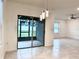 Bright living room area with sliding glass doors leading to the outside patio and neutral tile floors at 398 Citrus Isle Loop, Davenport, FL 33837
