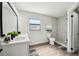 Modern bathroom featuring a double sink vanity, gray shower, and wood-look flooring at 413 Mainsail Ct, Lake Mary, FL 32746