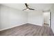 Bedroom with new paint, fan, and modern gray laminate flooring and doorway to hallway at 413 Mainsail Ct, Lake Mary, FL 32746