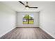 Bright bedroom with new paint, fan, and modern gray laminate flooring at 413 Mainsail Ct, Lake Mary, FL 32746