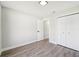 A bright bedroom with a closet and doorway shows modern gray laminate flooring at 413 Mainsail Ct, Lake Mary, FL 32746