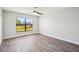 Bright bedroom with new paint, fan, and modern gray laminate flooring at 413 Mainsail Ct, Lake Mary, FL 32746