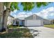 Traditional home with a two-car garage, manicured lawn, and inviting entrance at 413 Mainsail Ct, Lake Mary, FL 32746