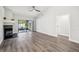 Cozy living room features a fan, wood-look flooring, modern fireplace, and natural light at 413 Mainsail Ct, Lake Mary, FL 32746