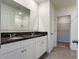 Bathroom featuring dual sinks, granite countertops and a large mirror at 5384 Palomino Pl, Apopka, FL 32712