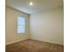 A cozy bedroom with a window and neutral carpeting, ready for personalization at 5384 Palomino Pl, Apopka, FL 32712