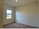 A sunlit bedroom featuring neutral walls and carpet, offering a blank canvas for decor at 5384 Palomino Pl, Apopka, FL 32712