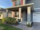 Inviting front porch with gray pillars, red door, and red shutters, perfect for relaxing outdoors at 5384 Palomino Pl, Apopka, FL 32712