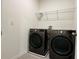 Laundry room with modern front-load washer and dryer, and wire shelving above at 5384 Palomino Pl, Apopka, FL 32712