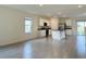 Spacious living room featuring tile floors, a modern kitchen, and ample natural light at 5384 Palomino Pl, Apopka, FL 32712