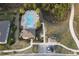 Aerial view of a community pool and amenity center with lush landscaping and mature palm trees at 5384 Palomino Pl, Apopka, FL 32712