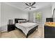 Well-lit bedroom with a black bed frame, neutral color scheme, and tile floors at 581 Brantley Terrace Way # 209, Altamonte Springs, FL 32714