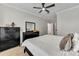 Bright bedroom with a bed dressed in white linens, dark furniture, and tile flooring at 581 Brantley Terrace Way # 209, Altamonte Springs, FL 32714