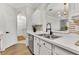 Modern kitchen sink with stainless steel faucet, white countertops, white cabinets and stainless steel appliances at 581 Brantley Terrace Way # 209, Altamonte Springs, FL 32714