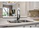 Modern kitchen sink with stainless steel faucet and white countertops, offering a stylish and functional workspace at 581 Brantley Terrace Way # 209, Altamonte Springs, FL 32714