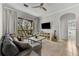 Comfortable living room featuring a modern ceiling fan, neutral colors, and an entrance to a screened balcony at 581 Brantley Terrace Way # 209, Altamonte Springs, FL 32714