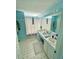 Bright bathroom with double sinks, a wide mirror and a shower with a curtain at 6037 Hickory Grove Ln, Port Orange, FL 32128