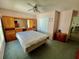 Bedroom featuring a large bed, built-in storage, and soft pink walls at 6037 Hickory Grove Ln, Port Orange, FL 32128
