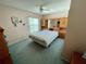 Cozy bedroom featuring a large bed, built-in cabinets, and a ceiling fan at 6037 Hickory Grove Ln, Port Orange, FL 32128